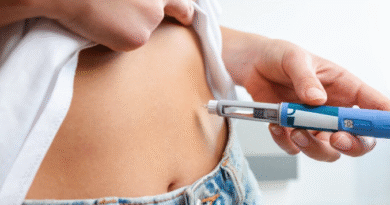 Woman injecting herself in the stomach with medication