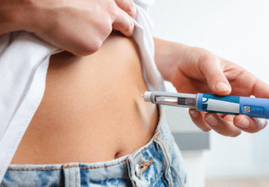 Woman injecting herself in the stomach with medication